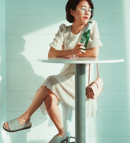 Person smiling peacefully in a bright, modern room.